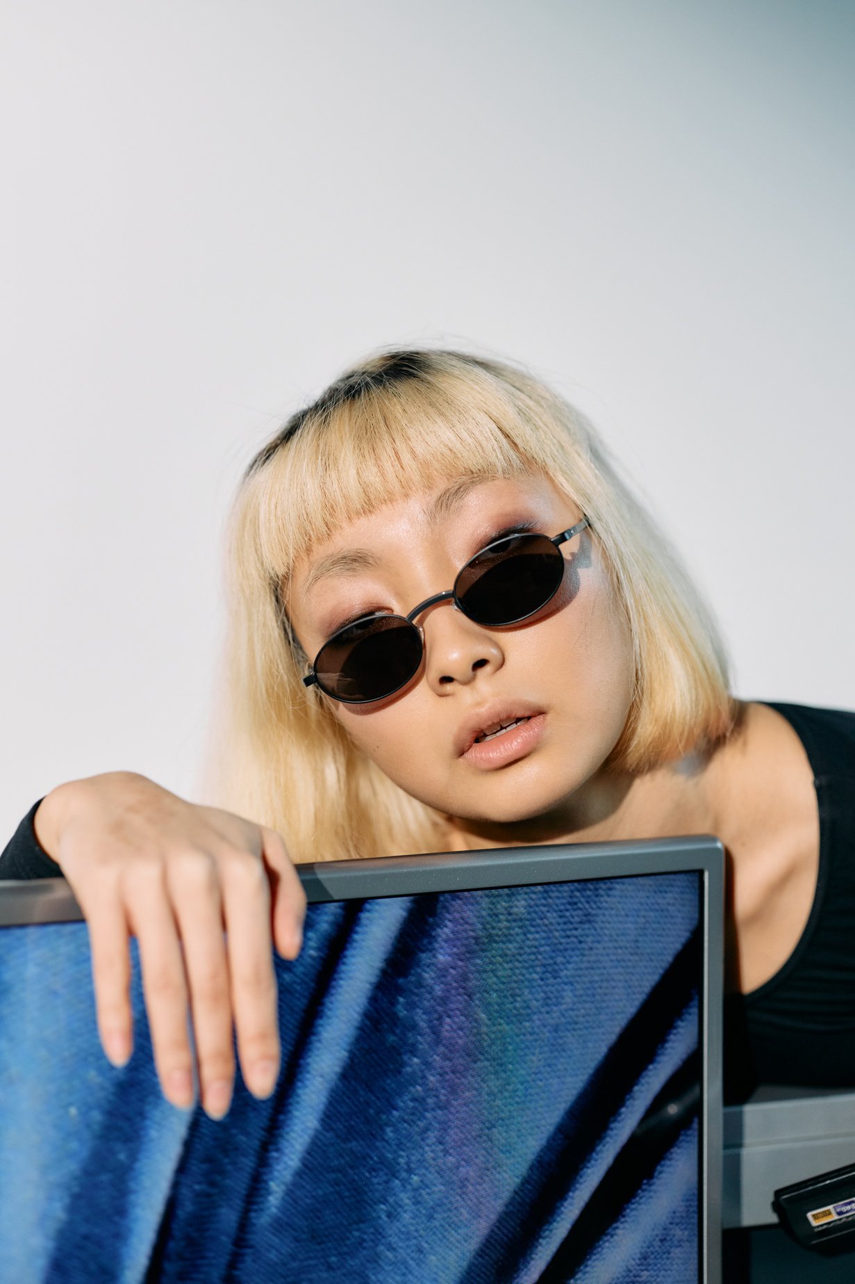 Close Up Photo of Woman Leaning on a Monitor